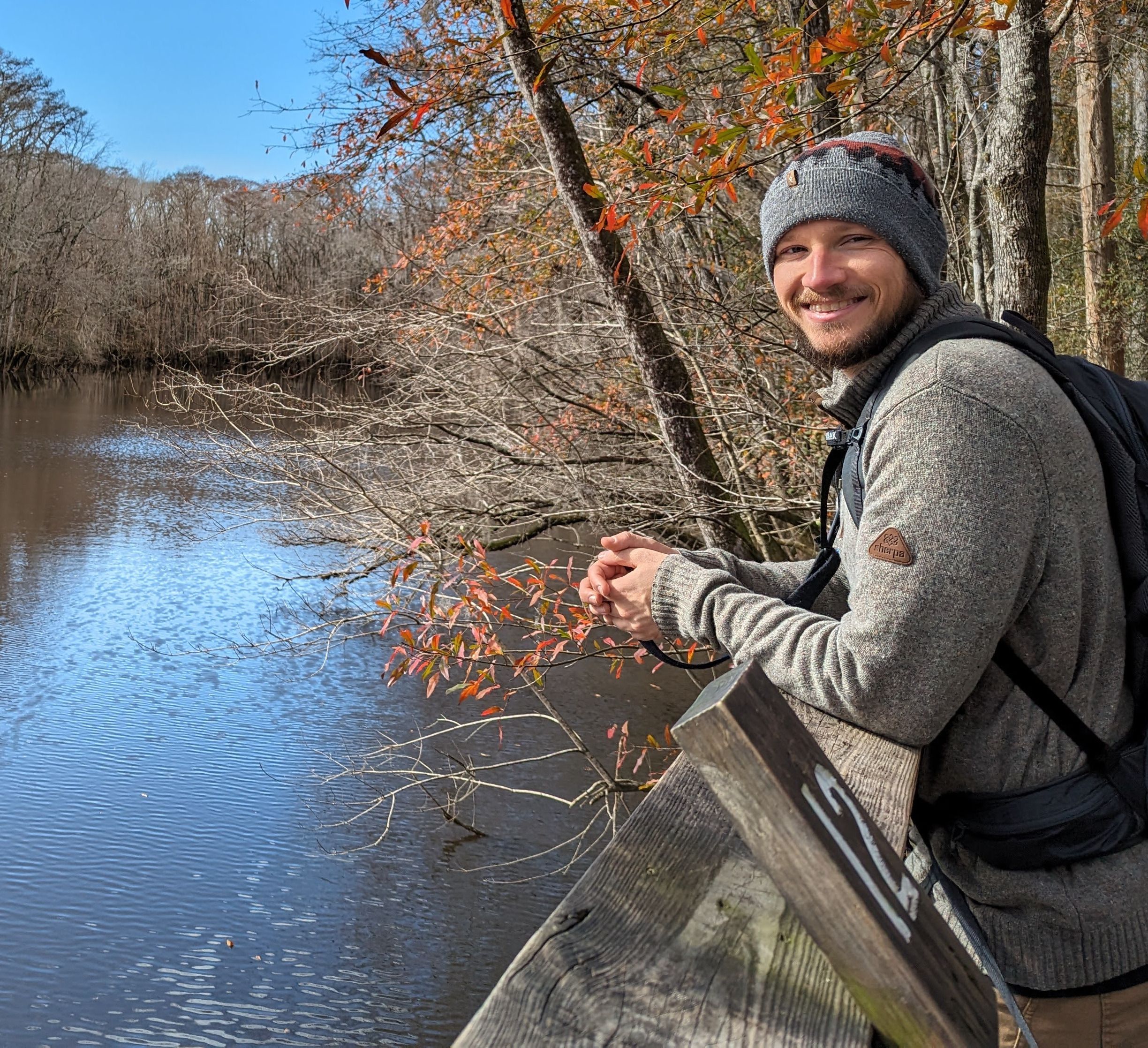 Chris leaning against a railing at Congaree National Park